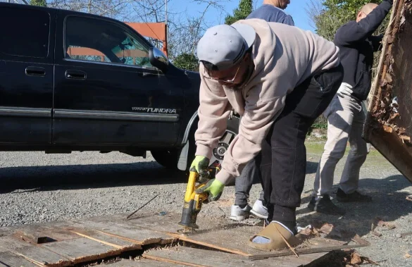 A man using a power tool on a piece of wood