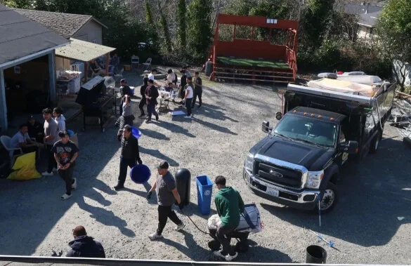 A group of people standing around a truck